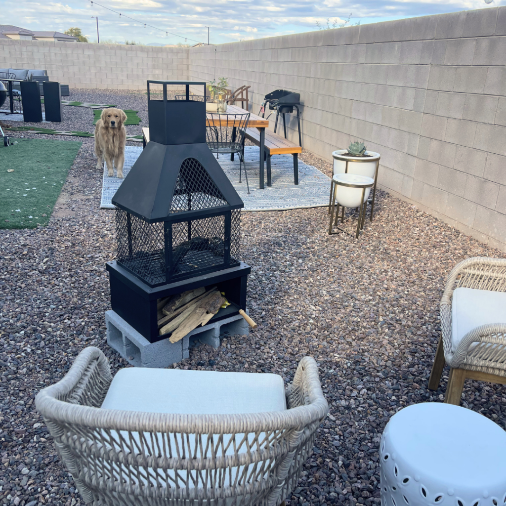 an arizona rental backyard with cement brick fence and stone with new furnishings and layout