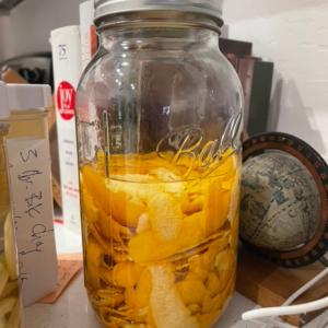 a jar with limoncello making from lemon peels